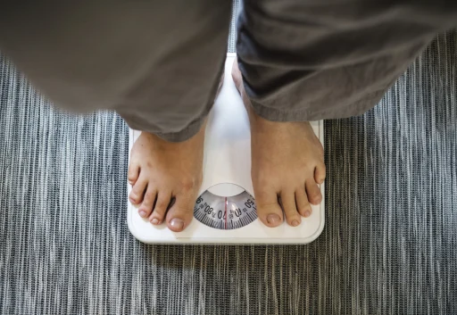 woman-standing-scale-scaled-e1791053600271